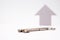 Grey arrow pointing up next to a key, symbolic image for incrising price and real estate market