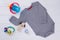 Grey baby onesie and toys