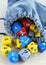 Grey bag, or pouch full of dices. Dice with question mark. Dices for rpg, board games, tabletop games or dungeons and dragons.