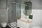 Grey bathroom interior with shower stall with glass walls, mirror bath sink, fauset, wc.  Bathroom interior