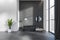 Grey bathroom interior with tub, table with accessories and panoramic window