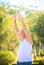 Grey Bearded Old Man in White Vest Bends Body in Park