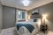 Grey bedroom boasts large iron bed