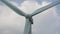 Grey blades rotate on alternative energy source windmill