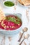Grey bowl with beetroot sauce with dill and nuts
