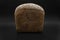 Grey bread loaf isolated on black background