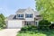 A grey and brick sided suburban home.