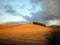 Grey cloud over large farmland