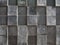 Grey concrete wall with geometric square pattern and distressed textures