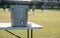 Grey cooler on a white plastic table on a football pitch ready for players to stop by during their break.