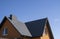 Grey corrugated metal profile roof installed on a modern house. The roof of corrugated sheet. Roofing of metal profile