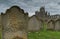 Grey cumulonimbus clouds over eroded gravestones with Whitby Abbey in the background. North Yorkshire.