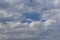 Grey Cumulus clouds in a bright blue sky