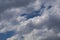 Grey Cumulus clouds in a bright blue sky