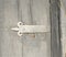 Grey door hinge on wooden door