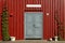 Grey door with red wooden wall