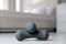 Grey dumbbells on floor indoors. Fitness at home