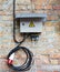 Grey electrical box on wall background