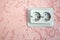 Grey electrical socket on pink decorative plaster wal