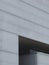 Grey faded background. Simple straight lines on office building in Madrid, Spain. Faded horizontal facade, conceptual, simplicity