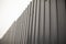 Grey fence made of metal. Solid high fence. Profiled metal is used in the fence of private territory