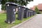 Grey garbage containers in a row