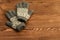 Grey gloves on old wooden background