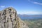 Grey granite cliffs of Seven Sister mountains, Norway with Donna island and blue Norwegian sea in background