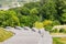 Grey granite stone stairs smoothly turning left in a city park. Forest and river on the background