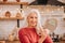 Grey-haired beautiful lady in red blouse looking at the mirror