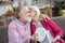 Grey-haired elderly lady kissing her husband feeling grateful