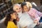 Grey-haired granddad reading a book to his granddaughters