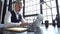 Grey-haired man working on a laptop. Serious mature man in elegant suit typing