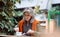 Grey haired senior woman eats delicious dessert sitting at table outdoors