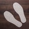 Grey insoles for shoes on wooden background