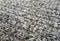 Grey knitted fabric texture as background. Beautiful pattern.