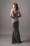 Grey lace evening dress. Beautiful model in bridesmaid dress, modern feminine look for an event. Women`s fashion.