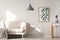 Grey lamp in bright living room interior with poster next to bei