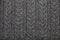 Grey melange cable knitting fabric textured background