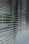 Grey metallic outdoor window blinds, office window with modern e