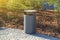 grey minimalist dustbin with mulched landscape in city park