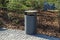 grey minimalist dustbin with mulched landscape in the park