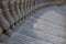 Grey mosaic stairs with marble column. Urban architecture background. Building detail.