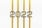 Grey numbers 2022 with golden ribbons isolated on white background.