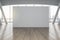 Grey partition with copyspace in sunny empty hall with grey columns, wooden floor and city view. 3D rendering, mockup