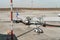 Grey passenger aircraft docked in airport getting ready for flight