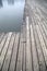 Grey pier and reflection of buildings on river picture