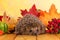 Grey prickly hedgehog sits on wooden table on background autumn leaves
