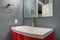 Grey and red bathroom design in a freshly renovated home.