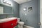 Grey and red bathroom design in a freshly renovated home.